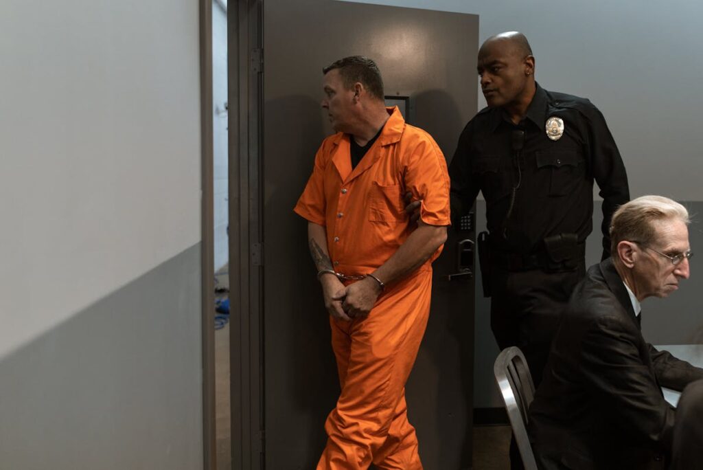 A Correctional Officer Escorting a Prisoner out of a Room