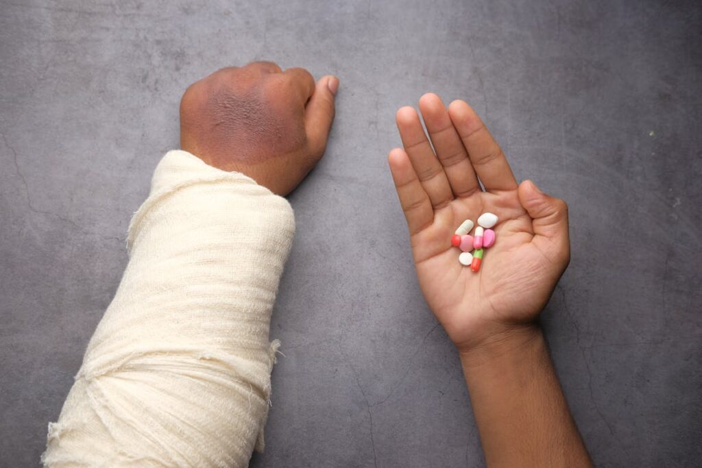 An Injured Person Holding Assorted Medicine