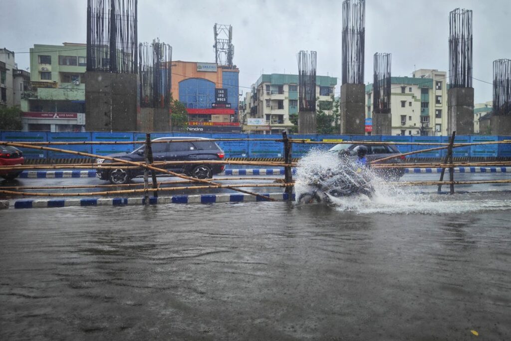 Cars Driving through a Flooded Street