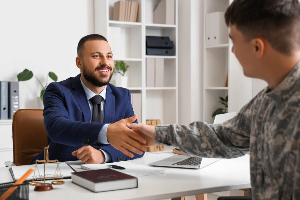 Male lawyer shaking hands with soldier in office